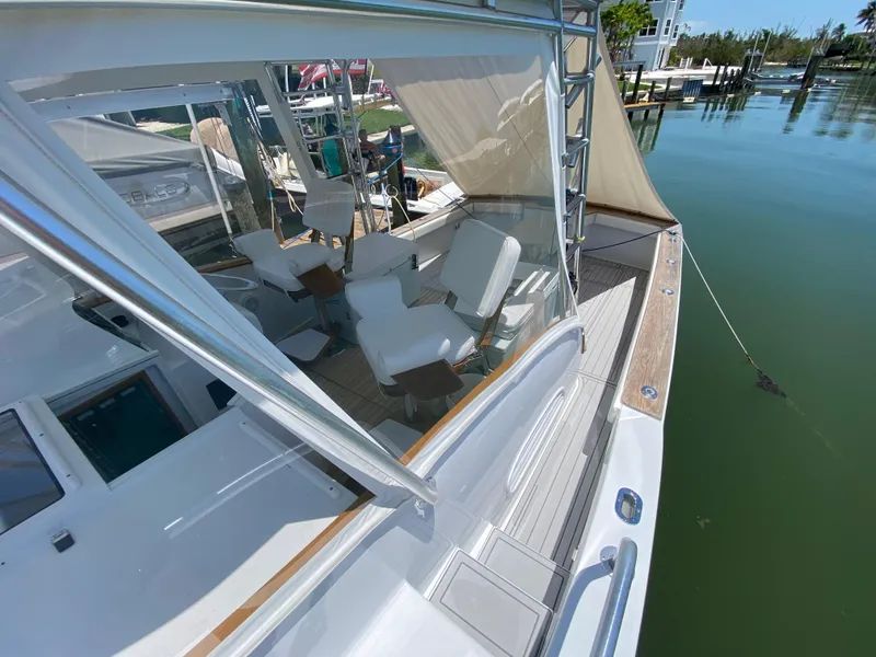 Slide: The Image of 1995 L&H 33 yacht with white seating, docked in a serene marina. - 30