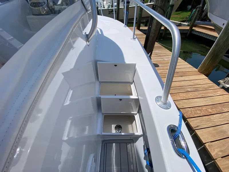 Slide: The Image of 1995 L&H 33 boat deck with open storage compartments, docked by wooden pier. - 34