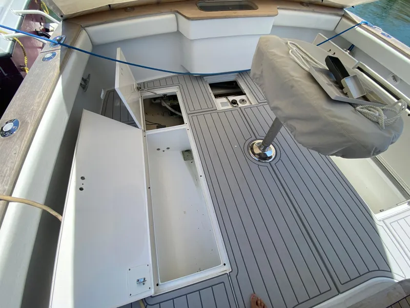 Slide: The Image of 1995 L&H 33 boat deck with open storage compartments and covered seat. - 38