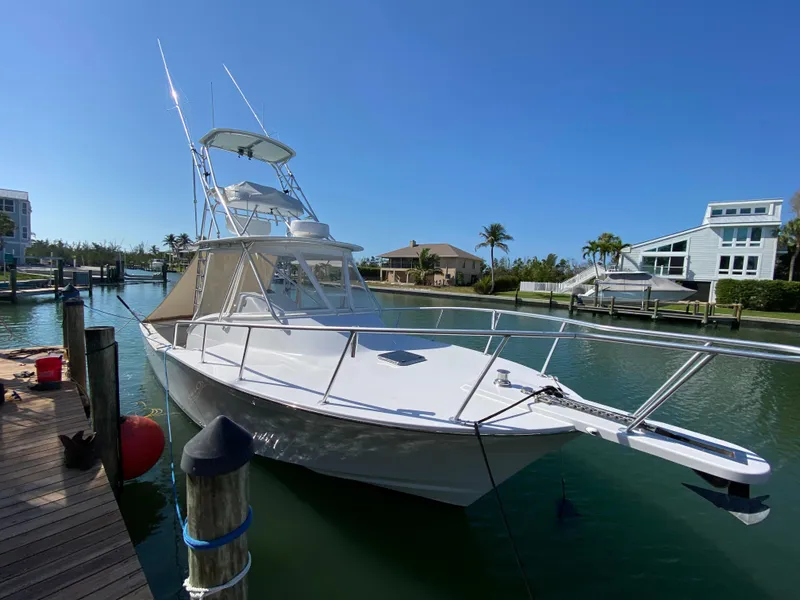 Slide: The Image of 1995 L&H 33 boat docked in a sunny marina with clear blue skies. - 5