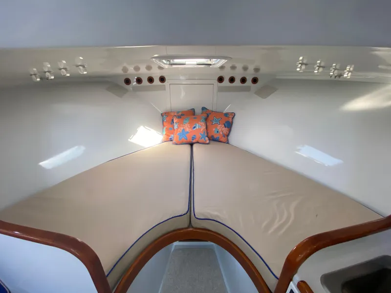 Slide: The Image of Cozy cabin interior of 1995 L&H 33 boat with starfish-patterned pillows. - 50