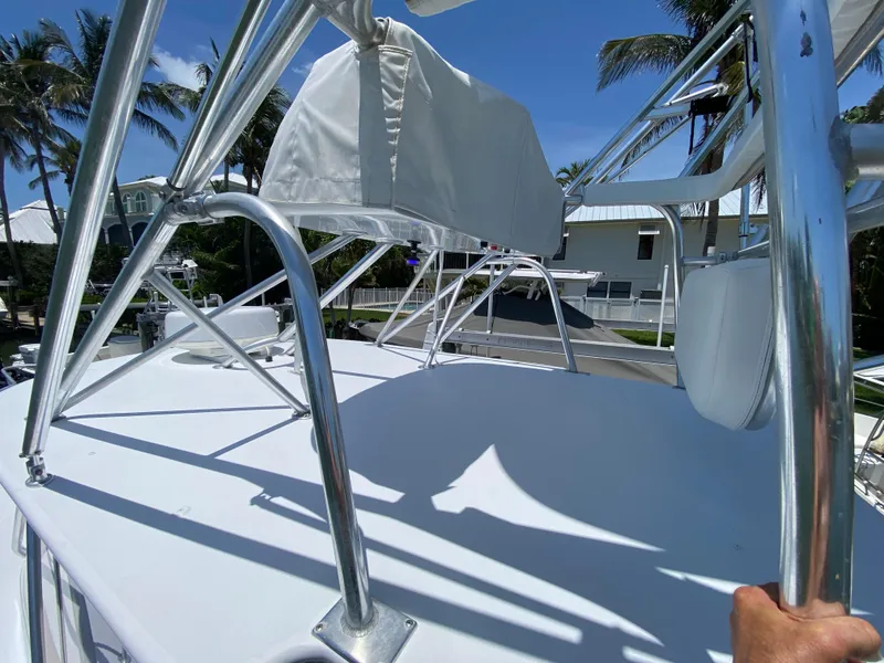 Slide: The Image of Rooftop view of a 1995 L&H 33 boat with metal railings and clear blue sky. - 58