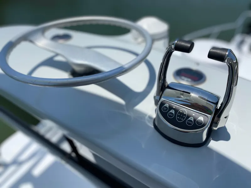 Slide: The Image of Steering wheel and controls of a 1995 L&H 33 boat. - 60