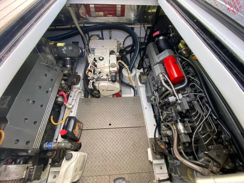 Slide: The Image of Engine compartment of a 1995 L&H 33 boat, showcasing mechanical components and wiring. - 65