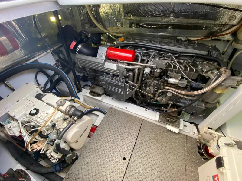 Slide: The Image of Engine room of a 1995 L&H 33 boat, featuring mechanical components and wiring. - 69
