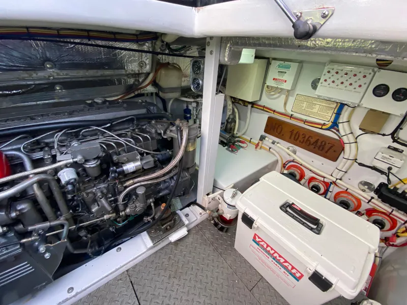 Slide: The Image of Engine room of a 1995 L&H 33 boat, featuring a Yanmar engine and control systems. - 70