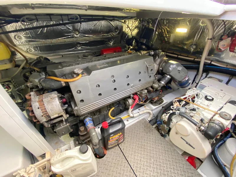 Slide: The Image of Engine room of a 1995 L&H 33 boat, featuring a well-maintained engine and components. - 71
