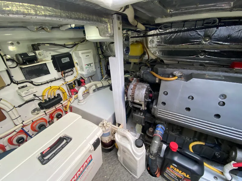 Slide: The Image of Engine room of a 1995 L&H 33 boat, featuring various mechanical components and equipment. - 72