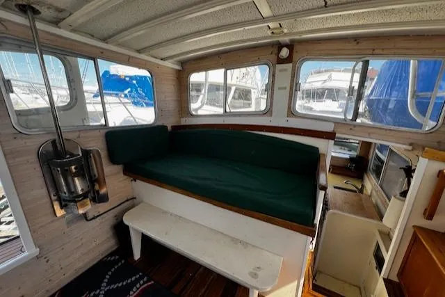 Slide: The Image of 1978 Bruno & Stillman Custom Cruiser/Sportfisherman interior with green seating and nautical decor. - 11