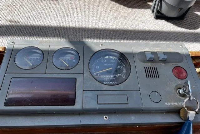 Slide: The Image of 1978 Bruno & Stillman boat dashboard with Yanmar gauges and controls. - 14