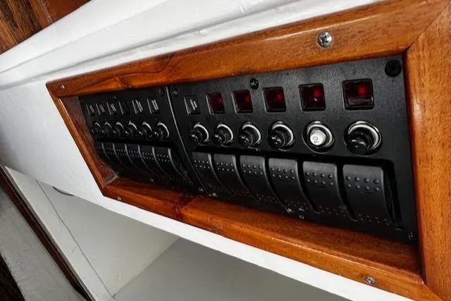 Slide: The Image of 1978 Bruno & Stillman Custom Cruiser control panel with wooden frame and switches. - 16