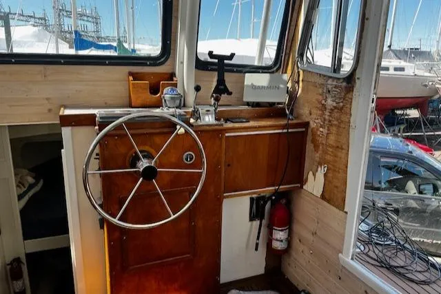 Slide: The Image of 1978 Bruno & Stillman Custom Cruiser interior with wooden helm and nautical equipment. - 2