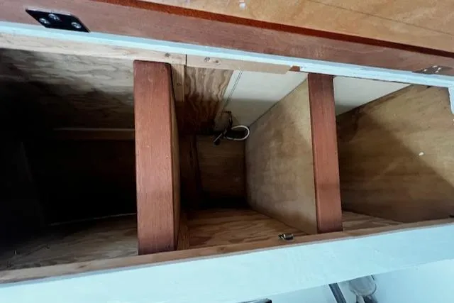 Slide: The Image of Interior view of a 1978 Bruno & Stillman Custom Cruiser/Sportfisherman, showcasing wooden compartments. - 24