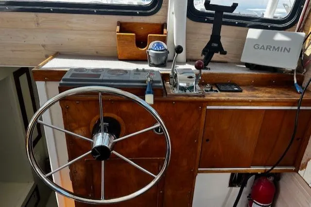 Slide: The Image of 1978 Bruno & Stillman Custom Cruiser helm with Garmin navigation and classic wooden finish. - 3