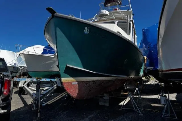 Slide: The Image of 1978 Bruno & Stillman Custom Cruiser/Sportfisherman boat on dry dock, blue sky background. - 34
