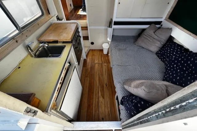 Slide: The Image of 1978 Bruno & Stillman Custom Cruiser interior with kitchenette and cozy seating area. - 5