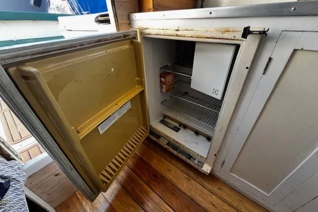 Slide: The Image of 1978 Bruno & Stillman Custom Cruiser fridge with open door, showing interior shelves. - 7