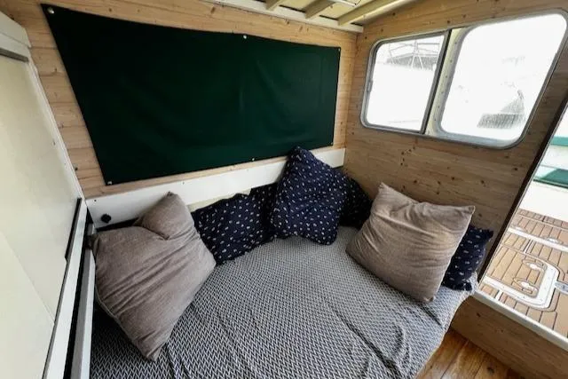Slide: The Image of Cozy interior of 1978 Bruno & Stillman Custom Cruiser with cushions and wooden paneling. - 8