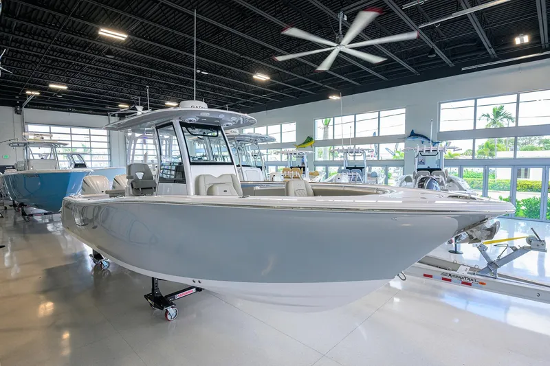 The Image of 2025 Sportsman Open 282 Center Console boat displayed in a showroom. - 0