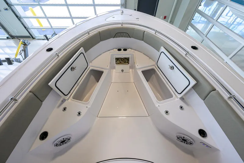 Slide: The Image of 2025 Sportsman Open 282 Center Console boat interior with storage compartments and seating. - 12