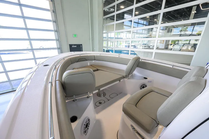 Slide: The Image of 2025 Sportsman Open 282 Center Console boat interior with cushioned seating and table. - 13