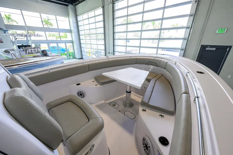 Slide: The Image of 2025 Sportsman Open 282 Center Console boat interior with seating and table. - 14