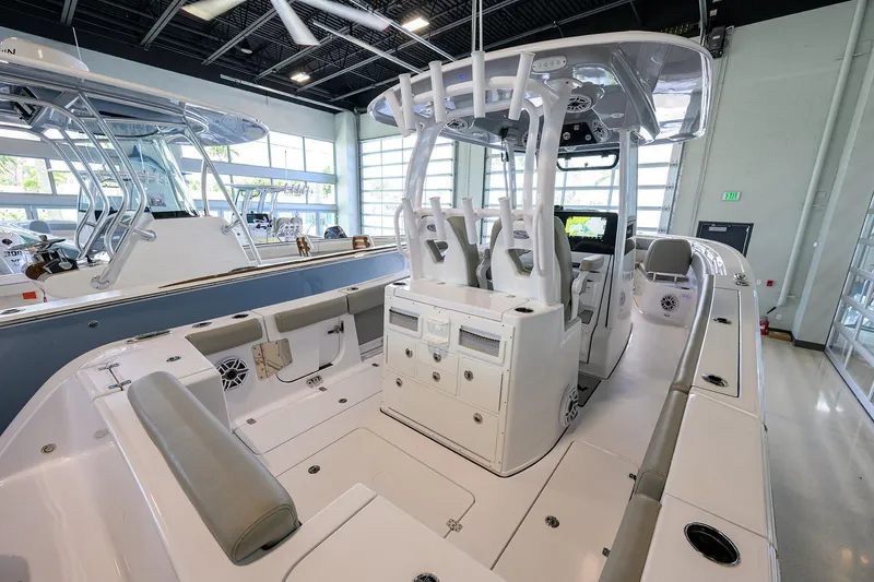Slide: The Image of 2025 Sportsman Open 282 Center Console boat interior in showroom setting. - 17