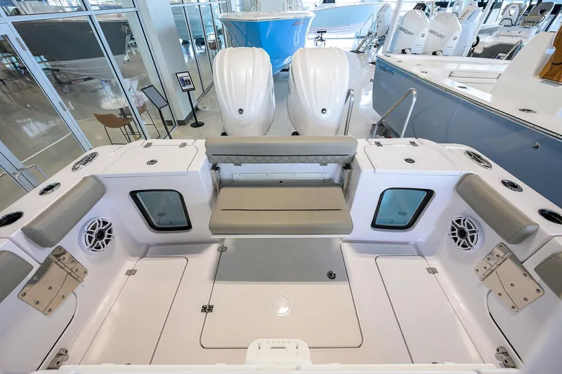 Slide: The Image of 2025 Sportsman Open 282 Center Console boat interior with seating and dual engines. - 22