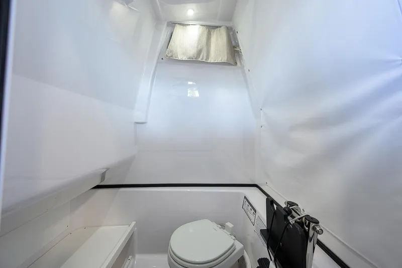 Slide: The Image of 2025 Sportsman Open 282 Center Console boat interior with modern marine toilet. - 24