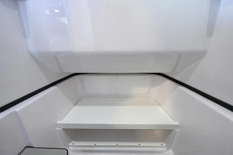 Slide: The Image of 2025 Sportsman Open 282 Center Console interior seating area, sleek white design. - 26