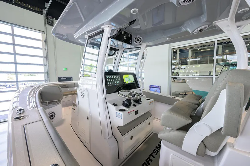 Slide: The Image of 2025 Sportsman Open 282 Center Console boat interior with modern navigation system and seating. - 5