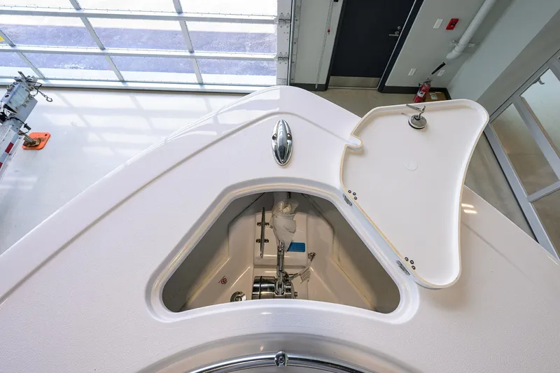 Slide: The Image of 2025 Sportsman Open 282 Center Console anchor locker with open hatch in a showroom. - 9