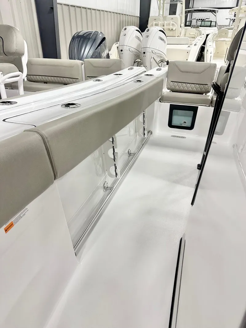 Slide: The Image of 2025 Sportsman Heritage 231 Center Console boat interior with seating and storage. - 10