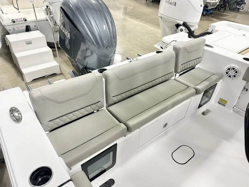 Slide: The Image of 2025 Sportsman Heritage 231 Center Console boat interior with cushioned seating and Yamaha engine. - 11