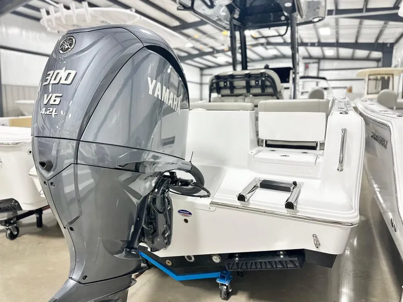 Slide: The Image of 2025 Sportsman Heritage 231 Center Console with Yamaha 300 V6 engine in a showroom. - 13