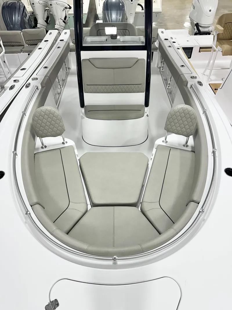 Slide: The Image of 2025 Sportsman Heritage 231 Center Console boat interior with cushioned seating and modern design. - 7