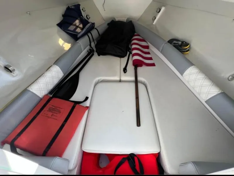 Slide: The Image of Interior of a 1999 Donzi 35 ZF boat with seating and storage items. - 11