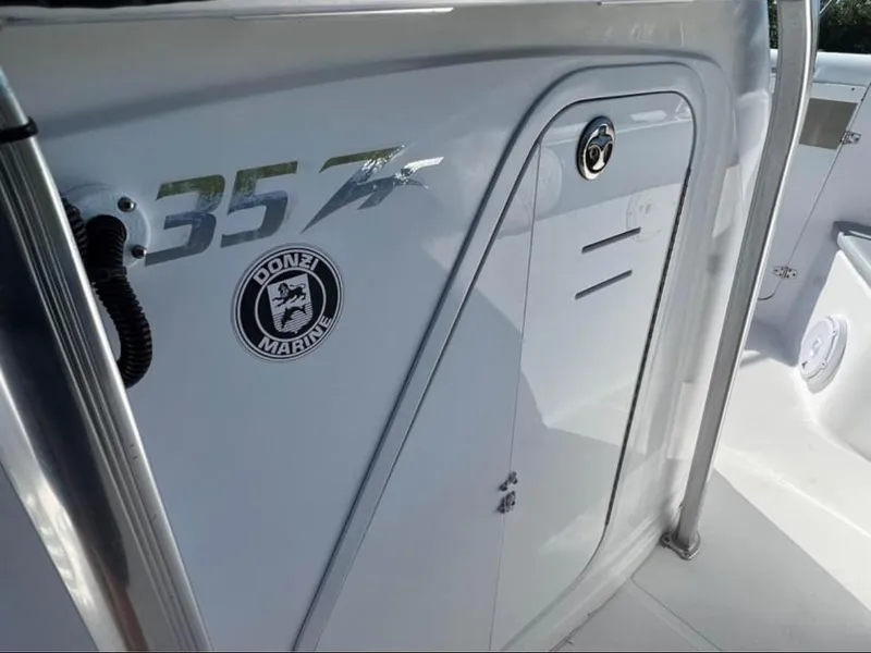 Slide: The Image of 1999 Donzi 35 ZF boat interior with logo and model number. - 12