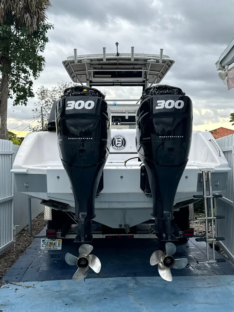 Slide: The Image of 1999 Donzi 35 ZF boat with twin 300 horsepower outboard engines, parked on a driveway. - 5