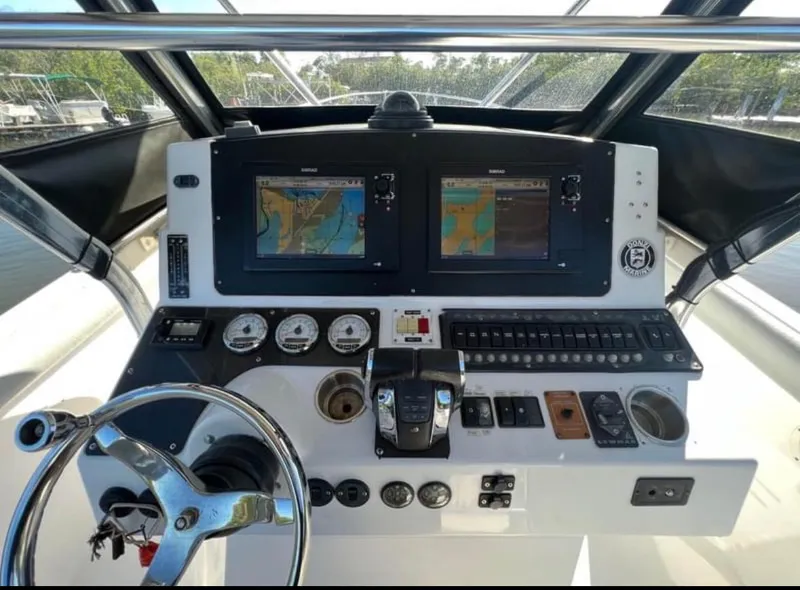 Slide: The Image of Control panel of a 1999 Donzi 35 ZF boat with navigation screens and gauges. - 6