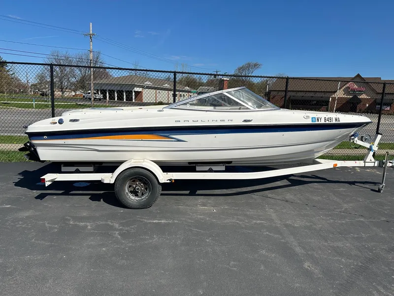 Slide: The Image of 2004 Bayliner 205 boat on trailer, parked outdoors on a sunny day. - 0