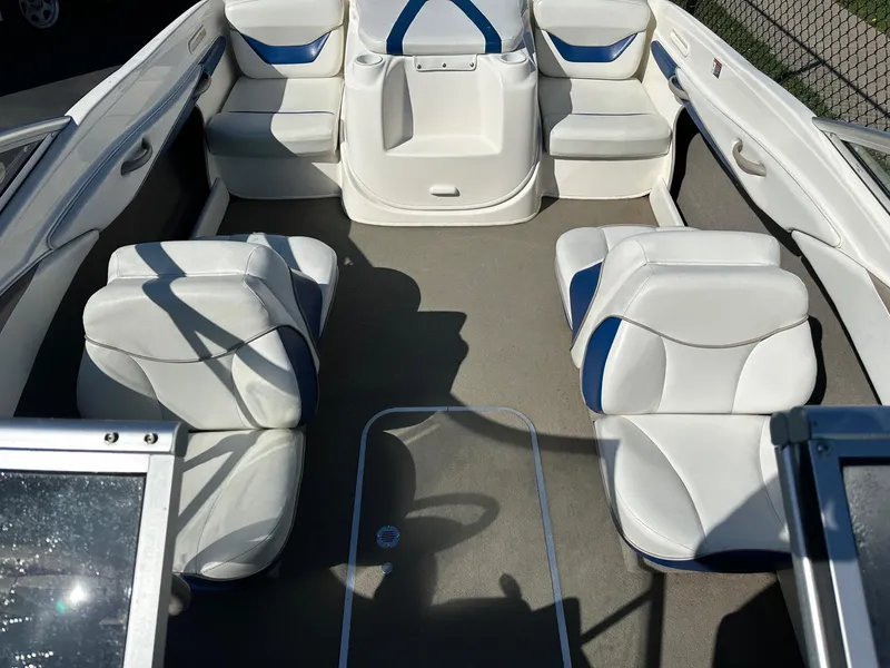 Slide: The Image of 2004 Bayliner 205 boat interior with white and blue seating arrangement. - 3