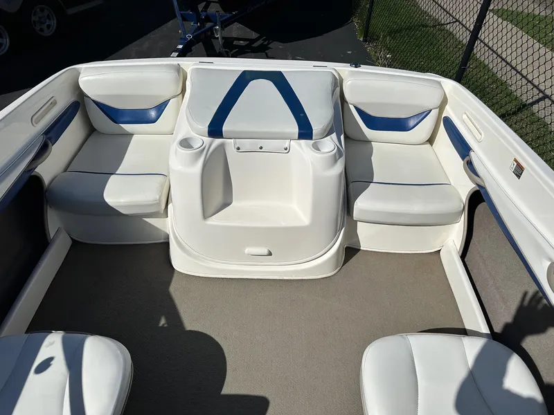 Slide: The Image of 2004 Bayliner 205 boat interior with white and blue seating arrangement. - 4