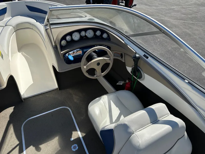 Slide: The Image of Interior of 2004 Bayliner 205 boat showing steering wheel and dashboard controls. - 5
