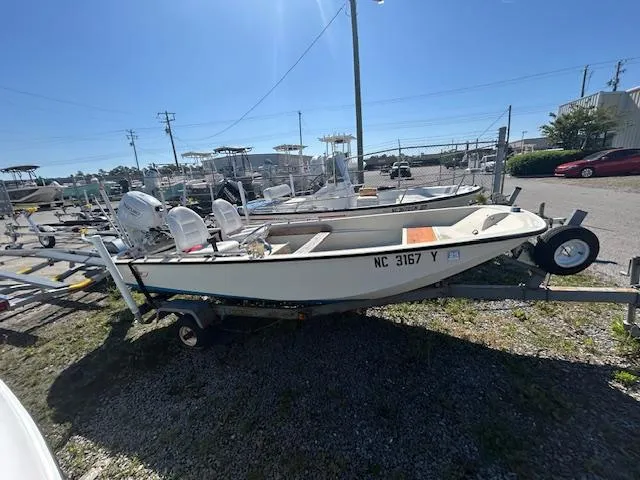 Slide: The Image of 1974 Boston Whaler 13 Sport boat on trailer in a marina setting. - 3