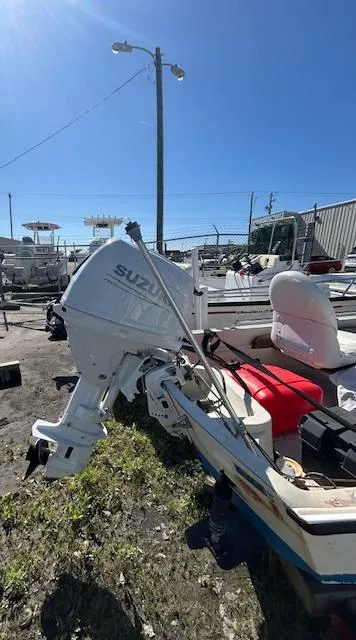 Slide: The Image of 1974 Boston Whaler 13 Sport with Suzuki outboard motor, parked outdoors on a sunny day. - 4