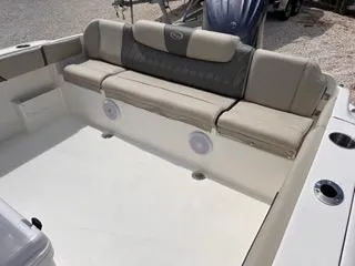 Slide: The Image of 2025 Key West 239 FS boat interior with cushioned seating and cup holders. - 11