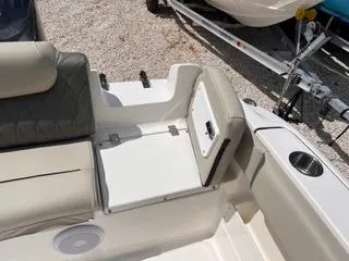 Slide: The Image of 2025 Key West 239 FS boat interior with beige seating and storage compartment. - 13