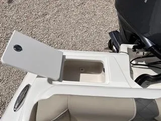 Slide: The Image of Key West 239 FS 2025 boat storage compartment with open lid, showcasing interior details. - 15