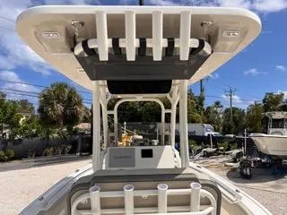 Slide: The Image of 2025 Key West 239 FS boat with rod holders and canopy, parked outdoors. - 25